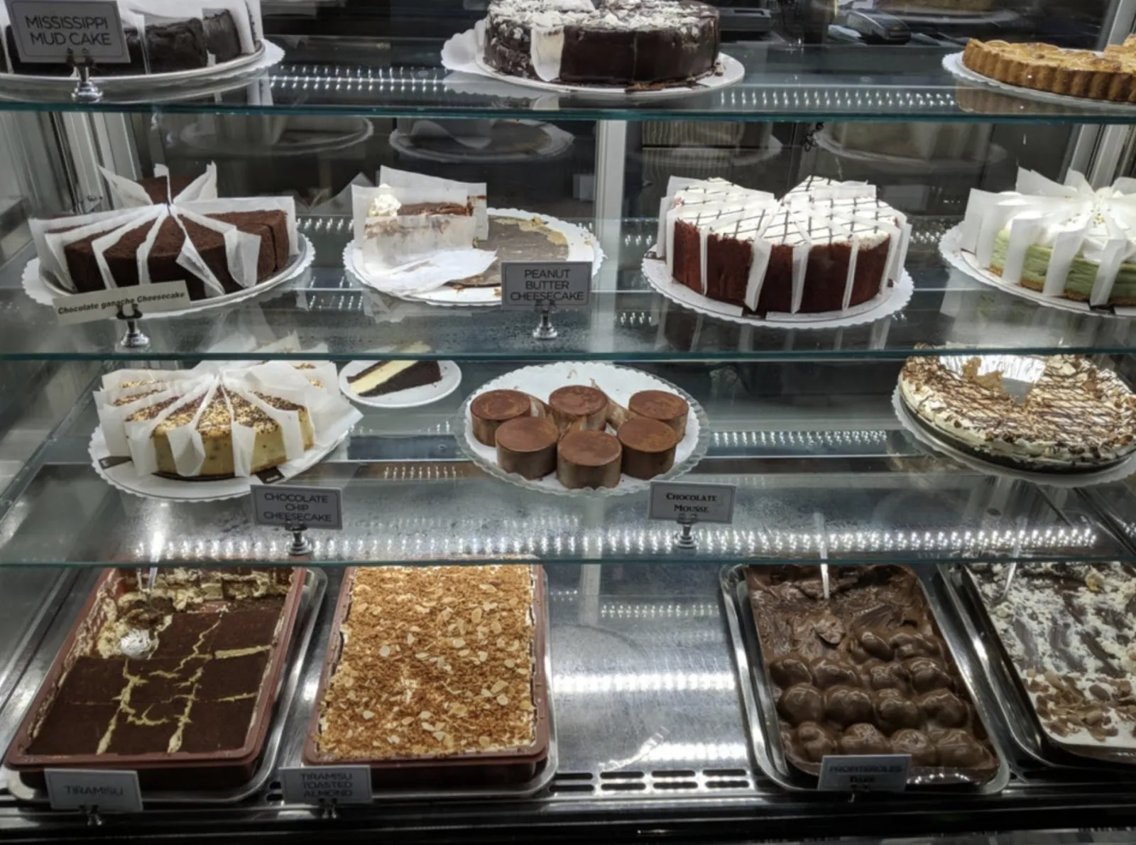 The full Caffè Palermo pastry case with cakes, tiramisu, and Italian desserts